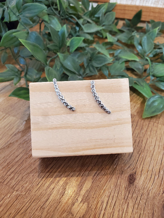 Boucle d'oreille barre strassé. colorie argent