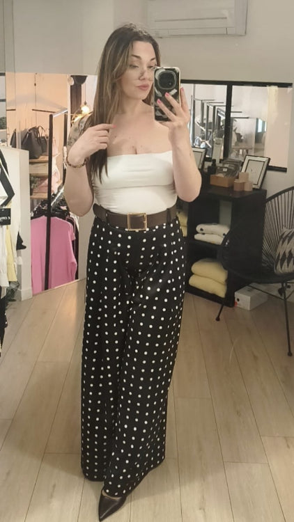Pantalon large noir a pois blanc vendu avec ceinture large marron. Photo porté. 