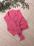 Chemise sans manches noué colorie rose.