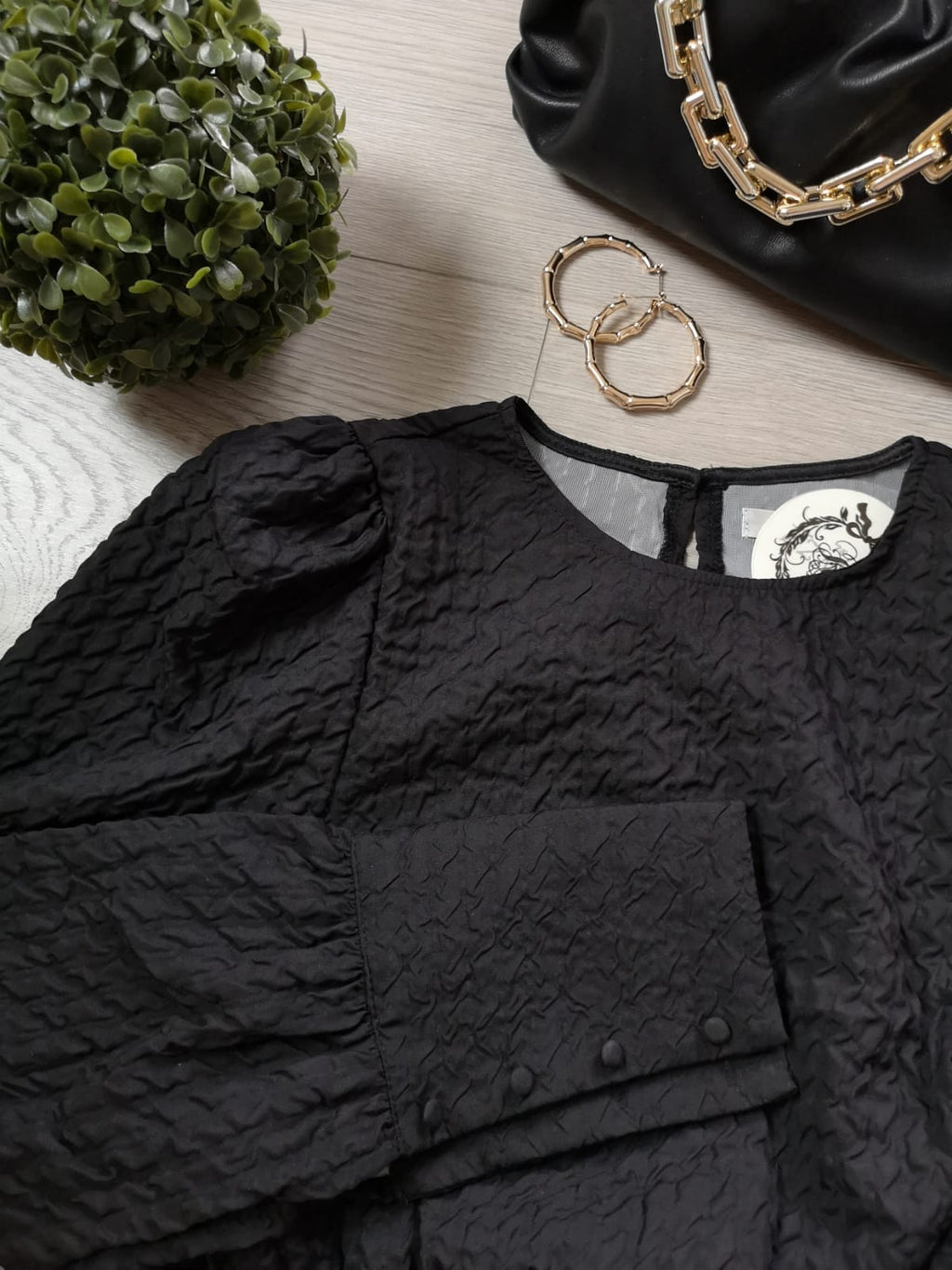 Photo a plat de la robe en tissus crêpe gaufré noir